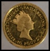 A One ounce fine gold Britannia dated 1991 £10 coin ( pounds ) Weight 3.5g