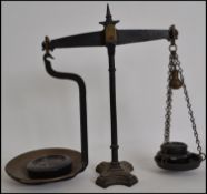 A pair of 19th century 4lb grocers cast metal balance scales fitted with a brass pan with weights.