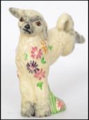 A 1930's Clarice Cliff for Newport Potteries model of a leaping spring lamb, with flowers around its