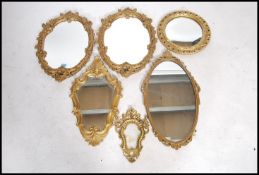 A collection of 20th century antique style gilt rococo wall mirrors of various shapes and sizes to