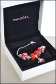 A Pandora charm bracelet complete with the presentation box, the charm marked Love with glass