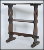An unusual mid century Art & Crafts ecclesiastical two tier peg jointed table being raised on lyre