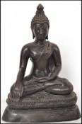 A 19th century cast  bronze buddha being sat in the lotus position and raised on a socle plinth base