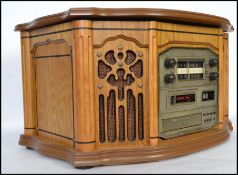 A Steepletone oak cased antique style hi-fi with inset record deck, cd, radio and tape deck.