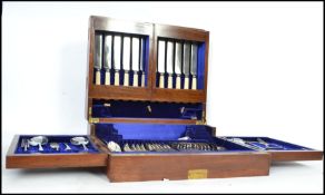 A good Edwardian large metamorphic mahogany cased canteen of cutlery. The case opening to reveal