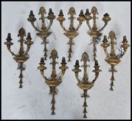 A set of seven early 20th antique century brass Adam style wall lights having a painted gilt