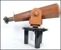 An unusual octagonal wood cased telescope mounted on a heavy metal swivel stand. The telescope