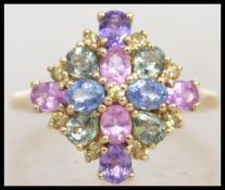 A 9ct gold ladies cluster ring adorned with multi coloured stones  in a lozenge formation. Size S.