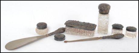 A collection of silver and cut glass ladies dressing table pots to include also shoe horn and button