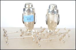 A pair of pepper condiments / pepperettes in the form of penguins with makers marks to the base