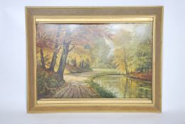 A retro mid century concave woodland scene print being set within a gilt frame