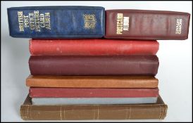A collection of 12x Edwardian and other vintage empty postcard albums, some with decorative covers.