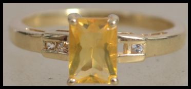 A hallmarked 9ct gold ring set with a yellow emera