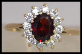 A hallmarked 9ct gold cluster ring set with a cent