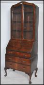 A 1930's Art Deco walnut bureau bookcase cabinet having fall front slope over drawers with twin