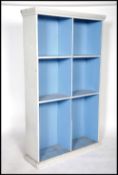 A 20th century painted shabby chic two tone school cupboard open window bookcase cabinet being