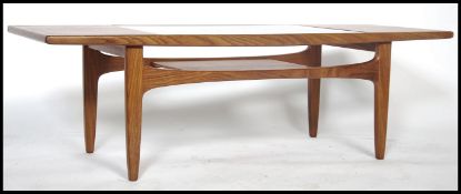A retro 1970's teak wood G Plan long John coffee table with drop in glass top with exposed slated
