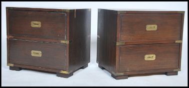 A pair of 20th century mahogany and brass bound campaign bedside cabinet chests . Each with inset