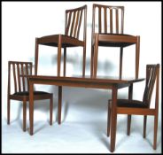 A 20th century Danish inspired teak dining table and 6 chairs by Meredew. The extending dining table
