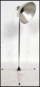 A vintage 20th century retro industrial Photax floor standing lamp raised on a tripod base with