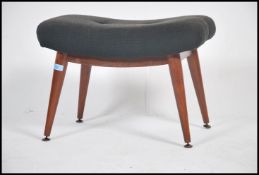 A retro 1960's stool in the manner of Ernest Race having teak wood tapering legs with black fabric