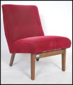 A 1950's retro bedroom chair being raised on tapering beech legs with original red velour fabric