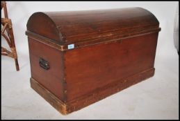 A Victorian style mahogany dome top trunk having panel worked sides with dome top and appointed