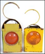 A pair of vintage 20th century industrial / motoring road lamps having three way apex red glass