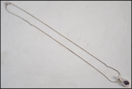 A contemporary silver cz and amethyst pendant and necklace chain set complete in the presentation