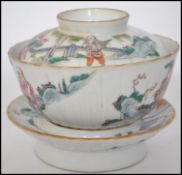 A believed 19th century Oriental ceramic lidded tea cup with stand depicting scenes of figures,