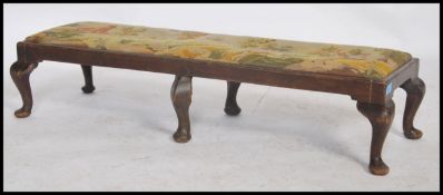 A 19th century oak framed  twin footstool the tapestry upholstered top depicting hunting scenes.