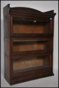 An Edwardian mahogany 3 section lawyers stacking bookcase by Lebus. Each section with hinged