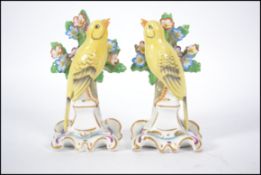 A true pair of 20th century believed Dresden / Meissen ceramic canaries on pedestal bases in front