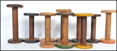 A group of 10 vintage multi coloured painted cotton weaving wooden bobbins from a Lancashire mill,