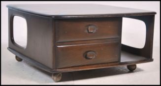 An original retro Ercol dark elm wood  Pandora coffee table with drawers and storage recesses having