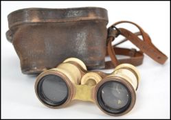 An early 20th century cased set of opera glasses / binoculars having  bone / ivory flashwork and set