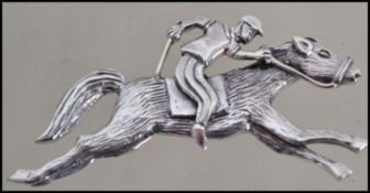 Hunting Interest. A silver jockey and rider horse brooch with pin to verso