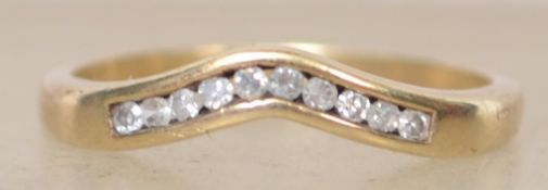 A hallmarked 9ct gold and diamond ring with channel set diamonds in a wishbone style. Hallmarked