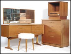 A G-Plan style teak wood dressing table and stool together with a similar teak wood pedestal chest