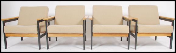 A set of 4 1970's school run - teachers lounge armchairs of ebonised tubular metal construction,