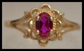 A hallmarked 9ct gold ring set with an oval cut ru