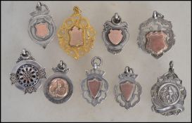 A collection of eight silver hallmarked fob medals dating from the late 19th century to include fobs