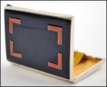 A silver hallmarked and enamel set vintage cigarette case. The black enamel panel with red corner