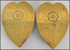 A pair of vintage believed 19th century heart shaped brass trivets with etched decoration being