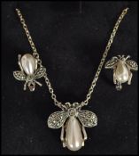 A ladies jewellery suite of silver and moonstone to include necklace, matching earrings and
