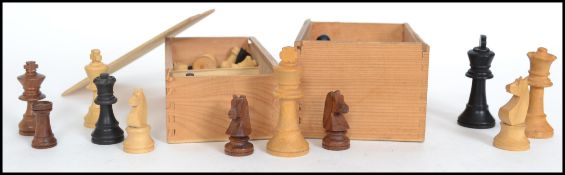 A collection of boxed chess pieces dating to the 20th century being of well carved construction
