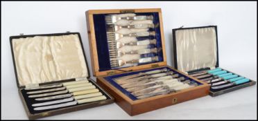 A good set of Edwardian mahogany cased mother of pearl handled silver collar knives together with
