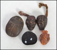 A pair of bronze tragedy and comedy masks along with an Oriental carved frog raised on a wooden