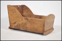 A 20th century wooden Elm crib, constructed from reclaimed elm using dove tails and peg joints.