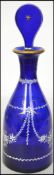 An early 20th century blue glass decanter having a hand painted decoration complete with stopper